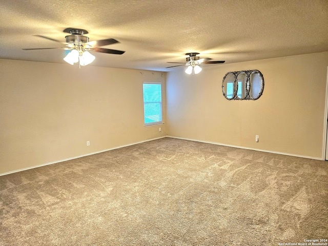 empty room featuring ceiling fan, a textured ceiling, and carpet floors