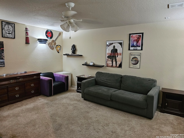 carpeted living room featuring a textured ceiling and ceiling fan