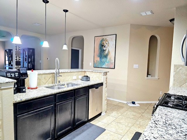 kitchen featuring light stone countertops, stainless steel dishwasher, sink, and pendant lighting