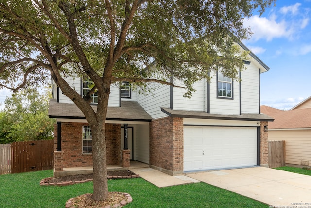 view of front of home featuring a front yard and a garage