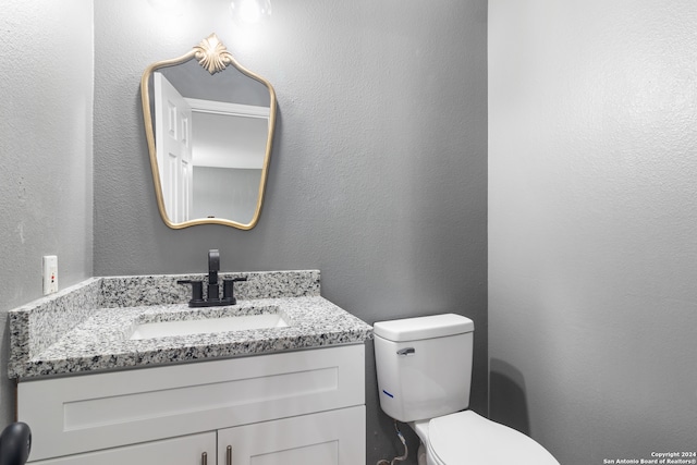 bathroom featuring toilet and vanity