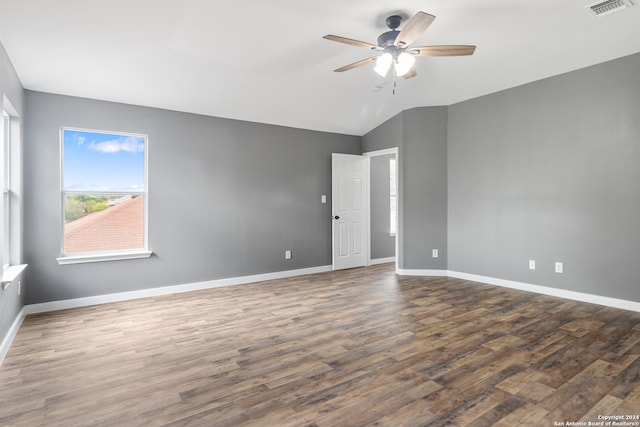 unfurnished room featuring lofted ceiling, ceiling fan, and dark hardwood / wood-style flooring