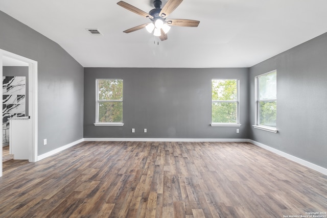 empty room with ceiling fan, dark hardwood / wood-style floors, and plenty of natural light