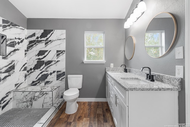 bathroom with toilet, walk in shower, vanity, and wood-type flooring