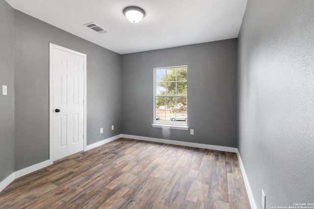 empty room with dark hardwood / wood-style floors