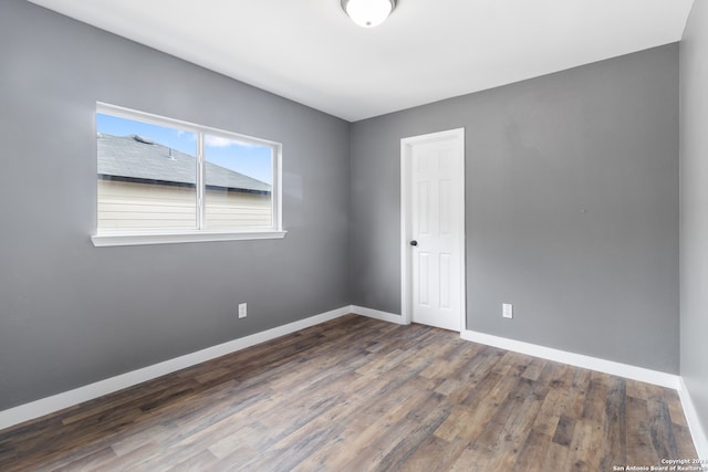 unfurnished room featuring dark hardwood / wood-style flooring