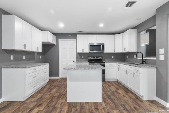 kitchen featuring a kitchen island, white cabinetry, dark hardwood / wood-style floors, sink, and stainless steel appliances