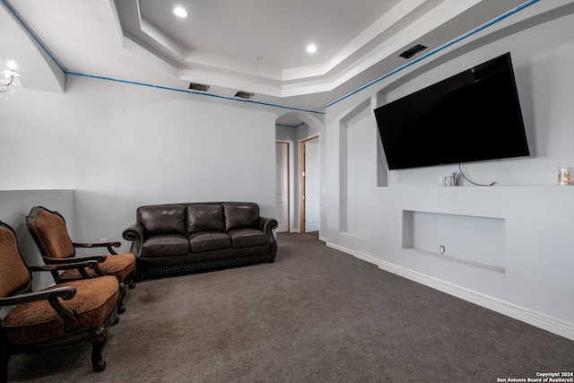 living room with carpet flooring and a raised ceiling