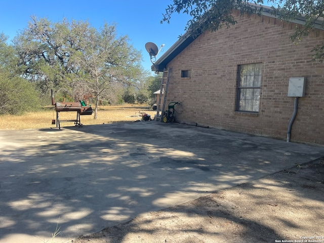 view of side of home with a patio