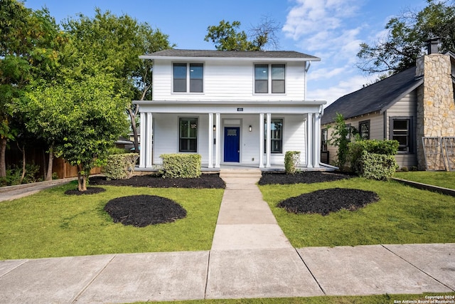 view of front of home featuring a front lawn and covered porch