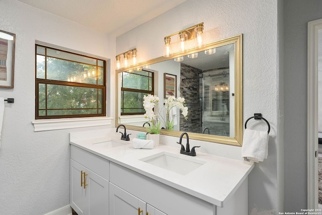 bathroom featuring a shower with door and vanity