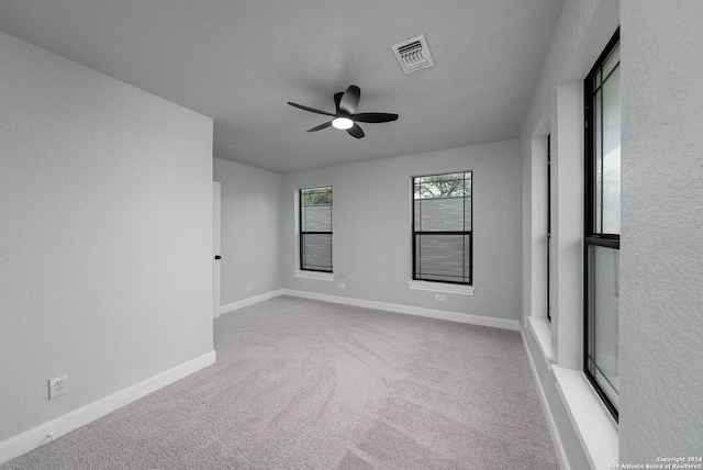 empty room with carpet and ceiling fan