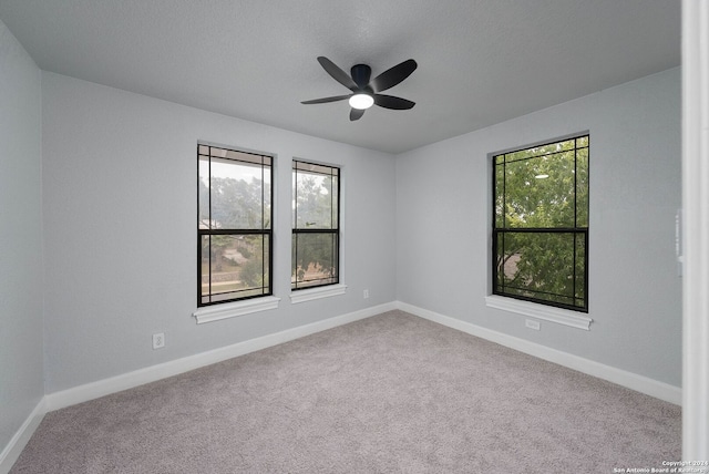 spare room featuring carpet and ceiling fan