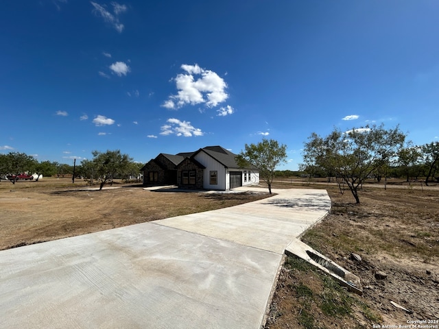 view of front of property with a rural view