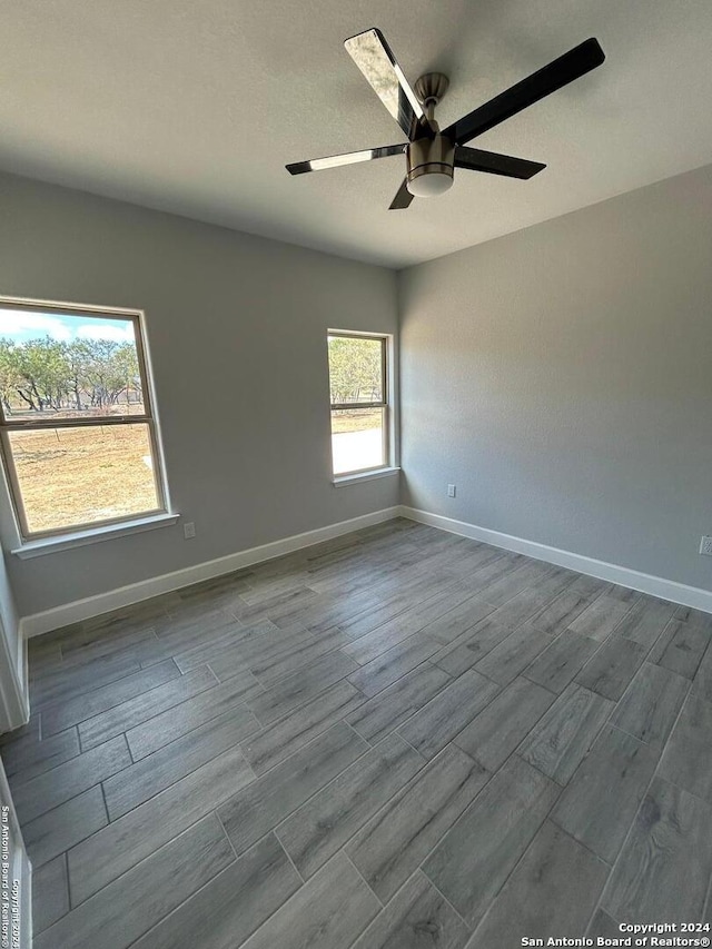 empty room featuring ceiling fan and light hardwood / wood-style flooring