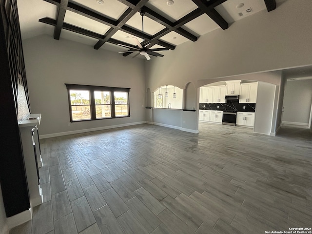 unfurnished living room with beam ceiling, ceiling fan, hardwood / wood-style floors, and coffered ceiling