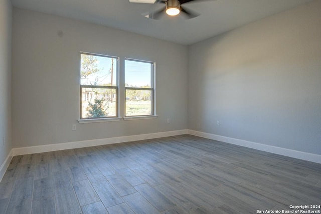 unfurnished room featuring light wood-type flooring and ceiling fan