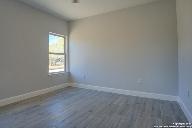 unfurnished room with light wood-type flooring