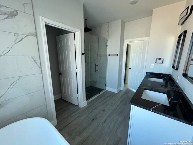 bathroom with vanity, wood-type flooring, and shower with separate bathtub