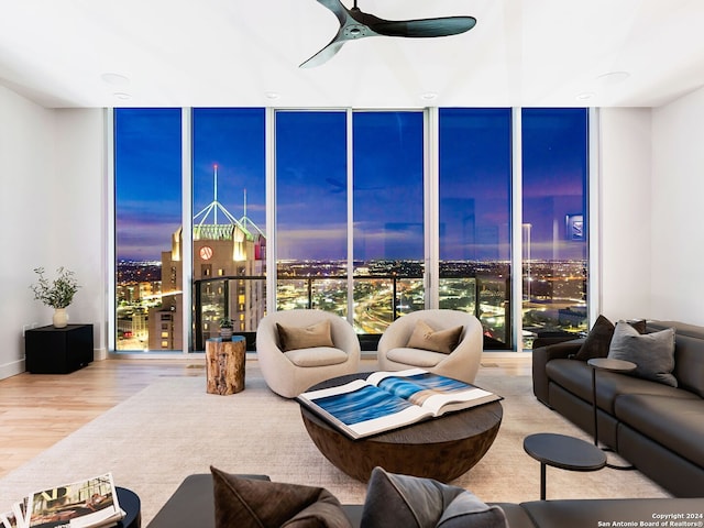 living room with floor to ceiling windows, hardwood / wood-style floors, and ceiling fan