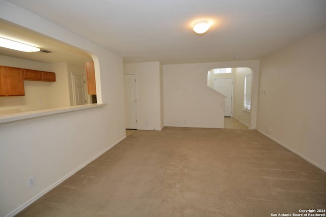 spare room featuring light colored carpet