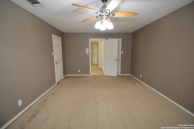 carpeted empty room with ceiling fan