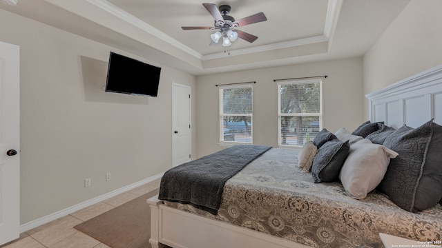 tiled bedroom with ornamental molding, a raised ceiling, and ceiling fan