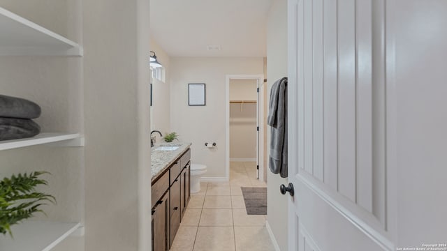 bathroom with vanity, toilet, and tile patterned flooring