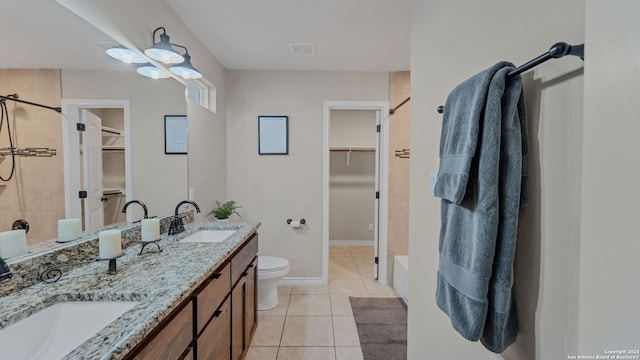 bathroom featuring toilet, vanity, and tile patterned flooring