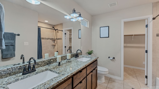 bathroom with vanity, toilet, tile patterned floors, and a shower with curtain