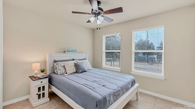 bedroom with ceiling fan and light tile patterned floors