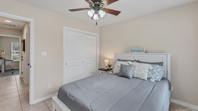 tiled bedroom with a closet and ceiling fan