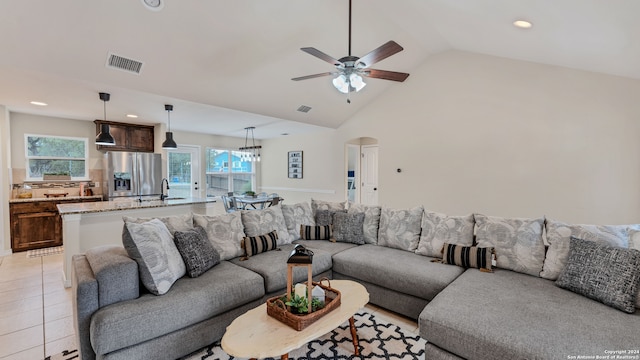 living room with sink, ceiling fan, high vaulted ceiling, and light tile patterned floors