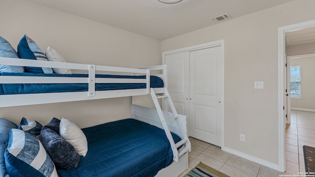 tiled bedroom featuring a closet