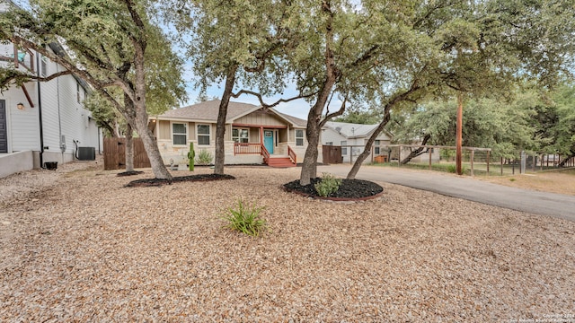 view of front of home with cooling unit and covered porch