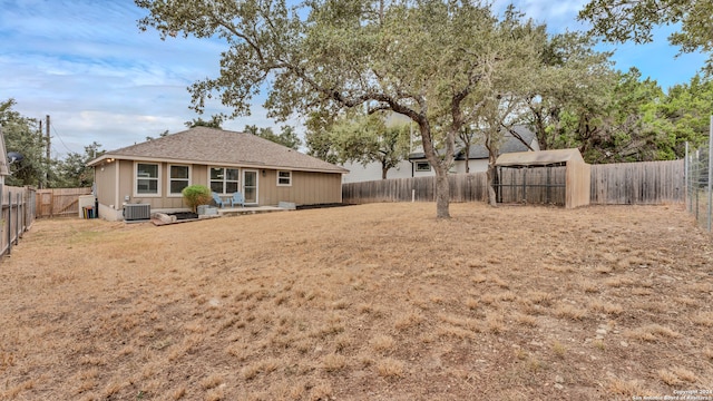 view of yard with cooling unit and a storage shed