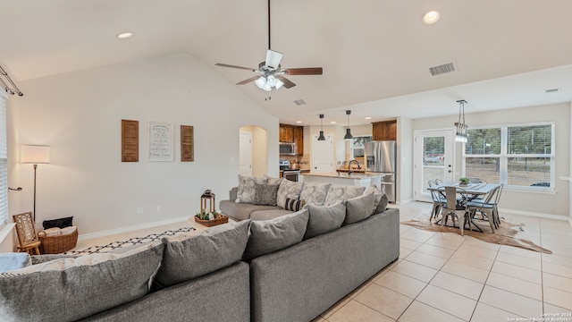 living room with sink, ceiling fan, high vaulted ceiling, and light tile patterned floors