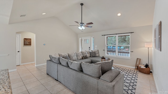 tiled living room with ceiling fan and high vaulted ceiling