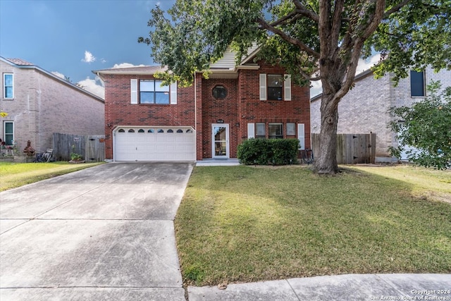 view of front of home with a garage and a front lawn