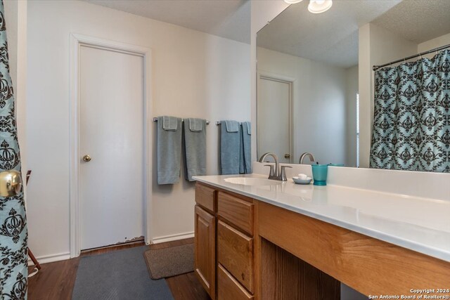 bathroom with vanity and hardwood / wood-style flooring