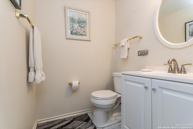 bathroom featuring toilet and vanity