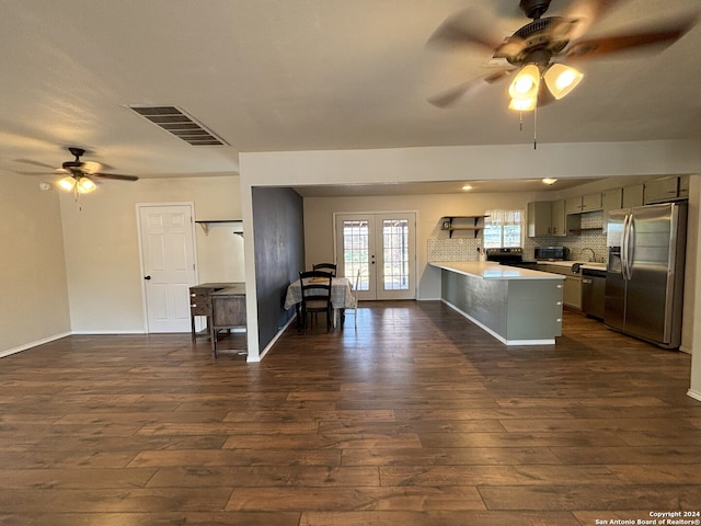 kitchen featuring decorative backsplash, french doors, dark wood-type flooring, stainless steel appliances, and ceiling fan