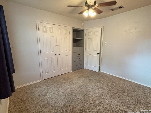 unfurnished bedroom with visible vents, carpet flooring, baseboards, and a closet