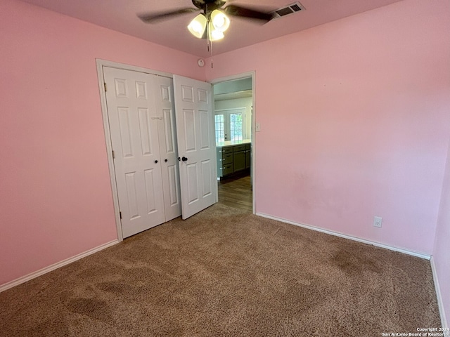 unfurnished bedroom featuring carpet floors, a closet, and ceiling fan