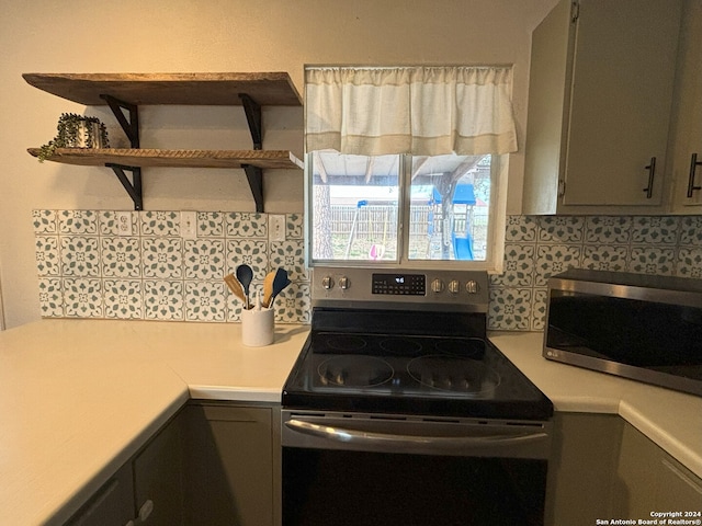 kitchen featuring light countertops, gray cabinets, decorative backsplash, and stainless steel appliances