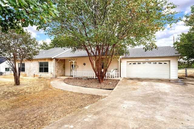 ranch-style home featuring a porch and a garage