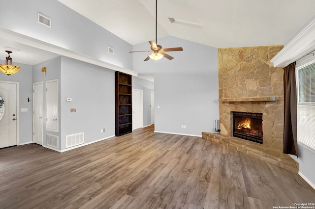 unfurnished living room with a fireplace, hardwood / wood-style flooring, high vaulted ceiling, and ceiling fan