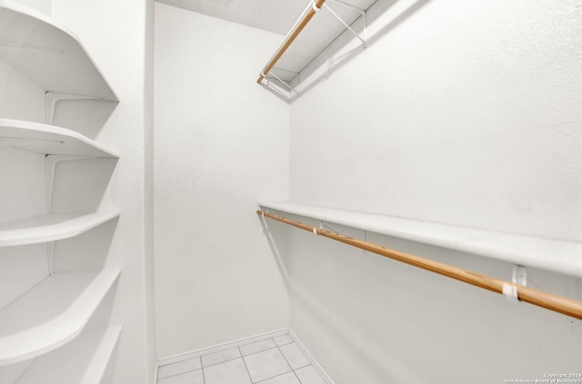 walk in closet with light tile patterned floors