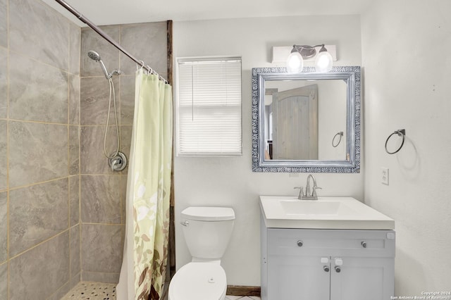 bathroom featuring toilet, walk in shower, and vanity