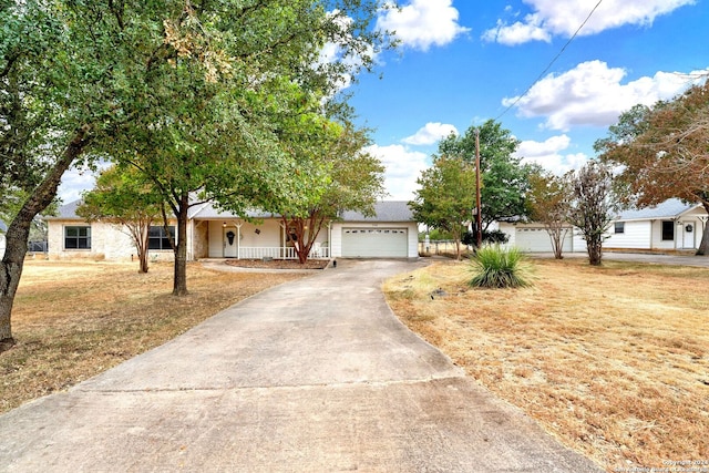 view of front of property featuring covered porch and a garage